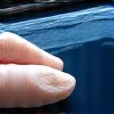 Clay bar being used on a car door panel.